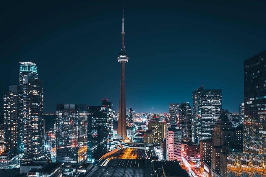 City skyline at night with illuminated buildings.